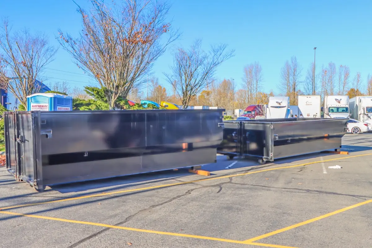 Professional dumpster rental service with roll-off container on residential driveway in Valinda